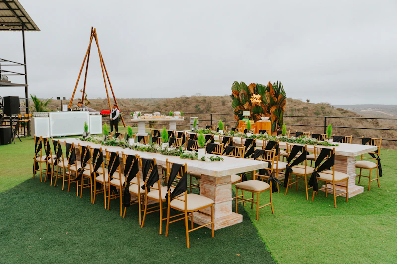 Long dining tables set for an outdoor birthday party event