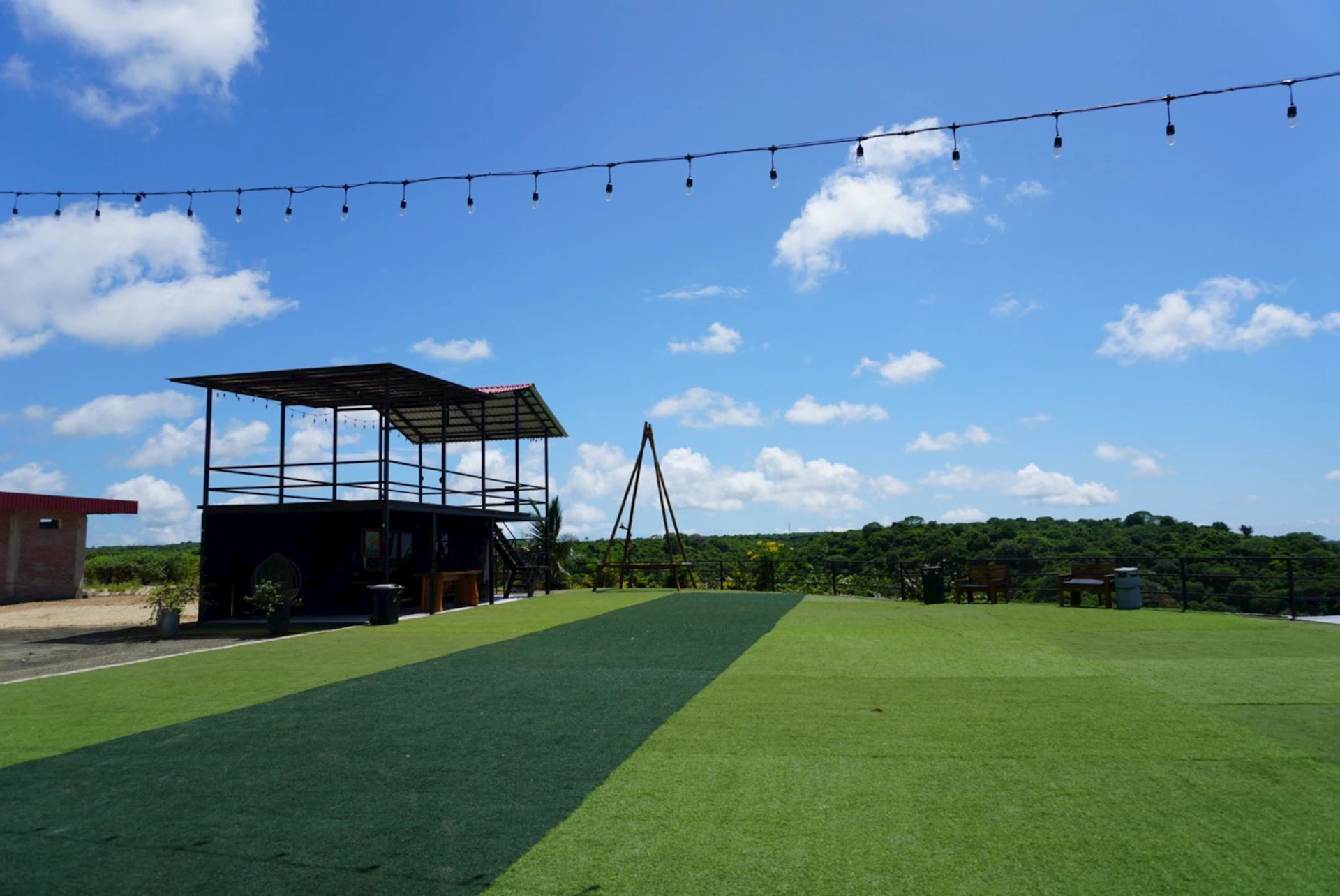 Outdoor venue with artificial turf and string lights