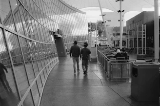 Two people walk down a modern walkway