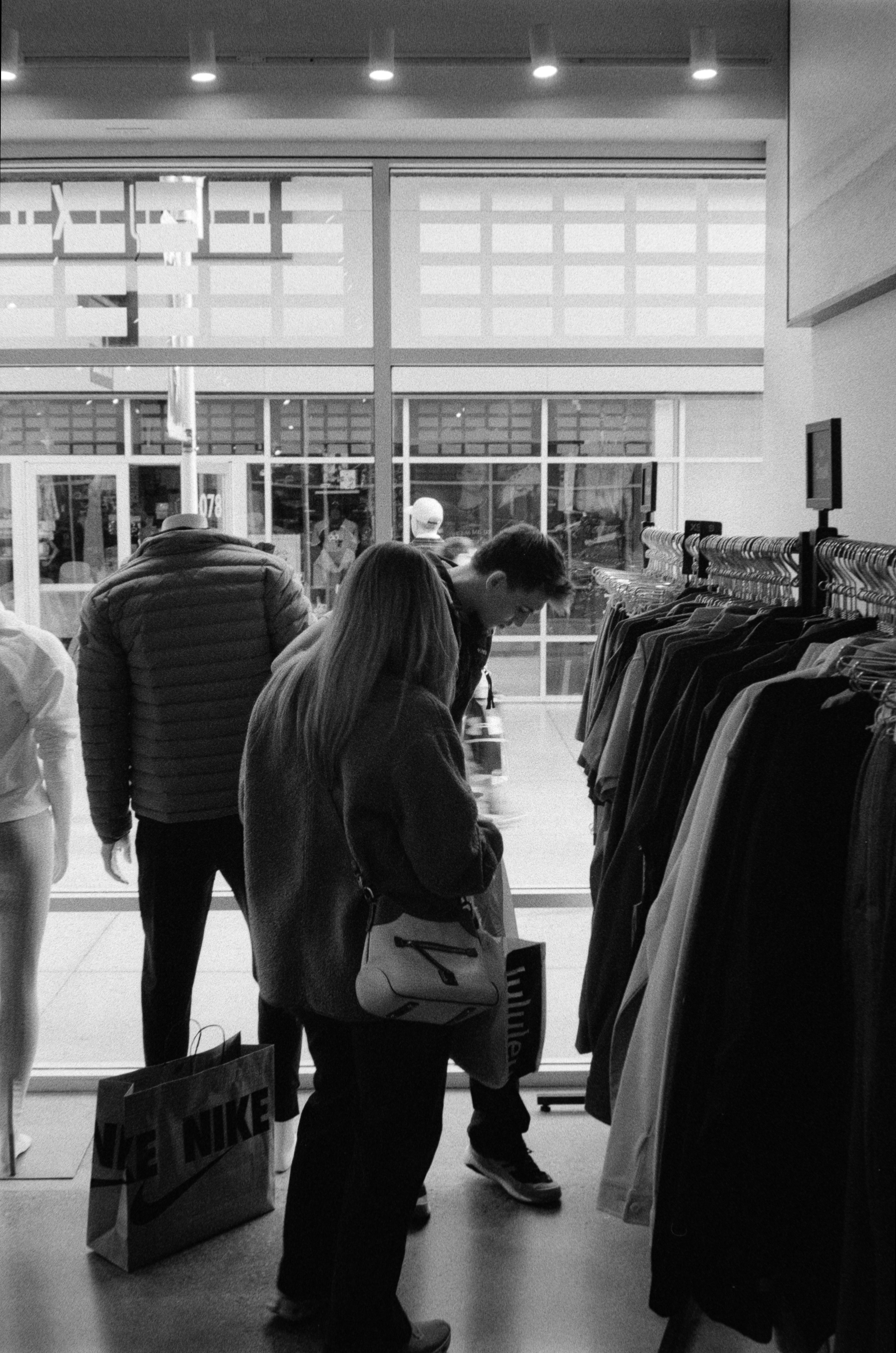 People shopping for clothes in a store.