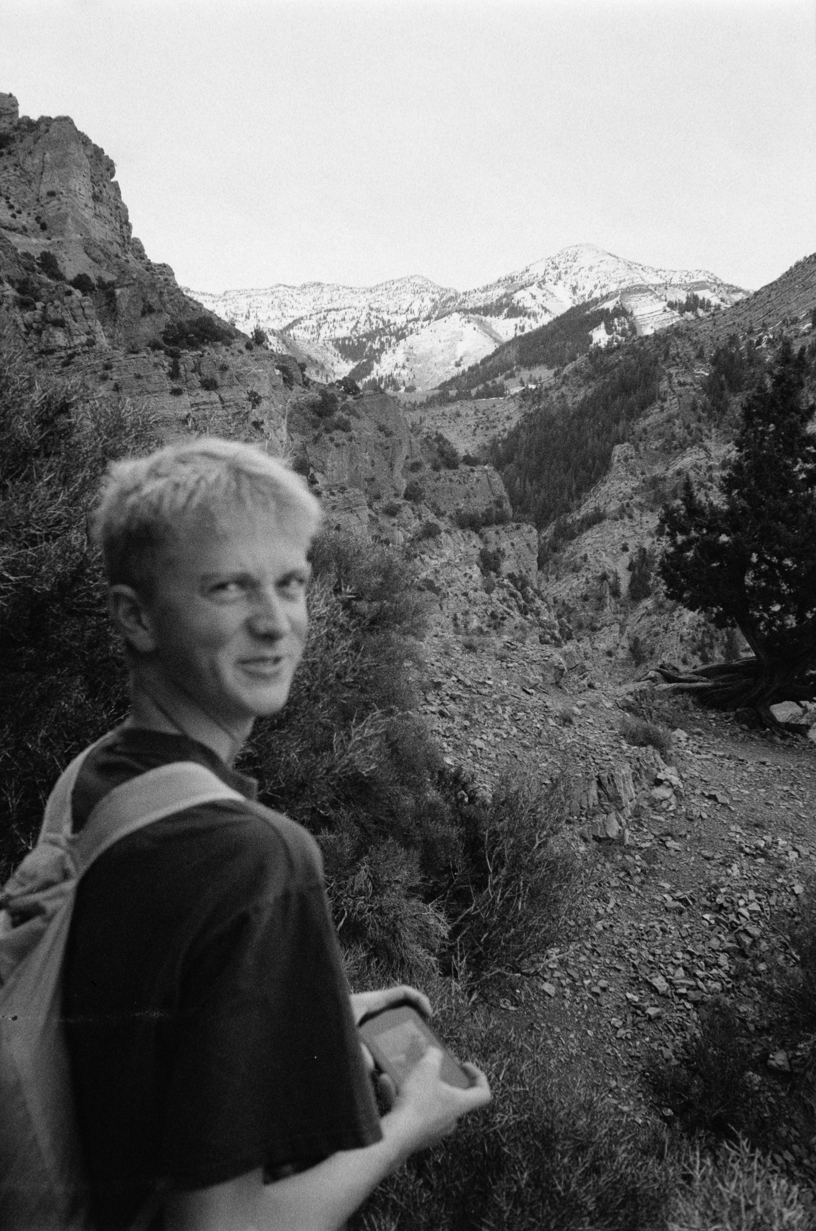 Man with backpack in a rocky mountain landscape