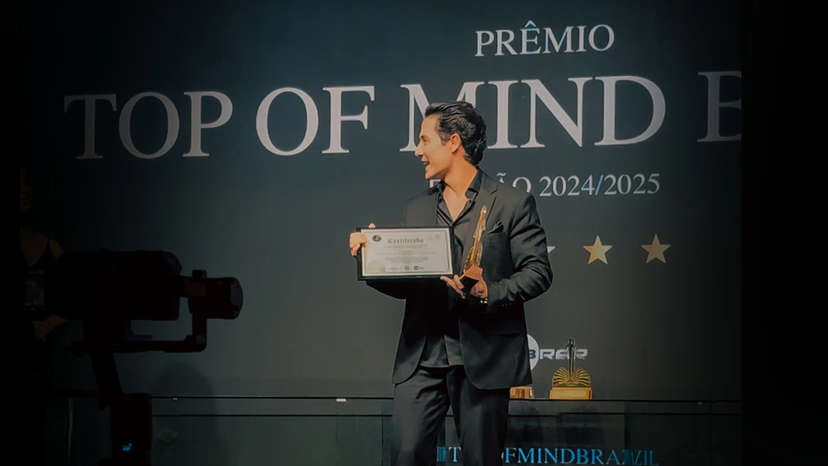 Man holding an award on stage