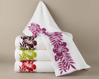 Stack of white towels with floral designs