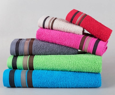 A stack of colorful folded towels with striped accents.
