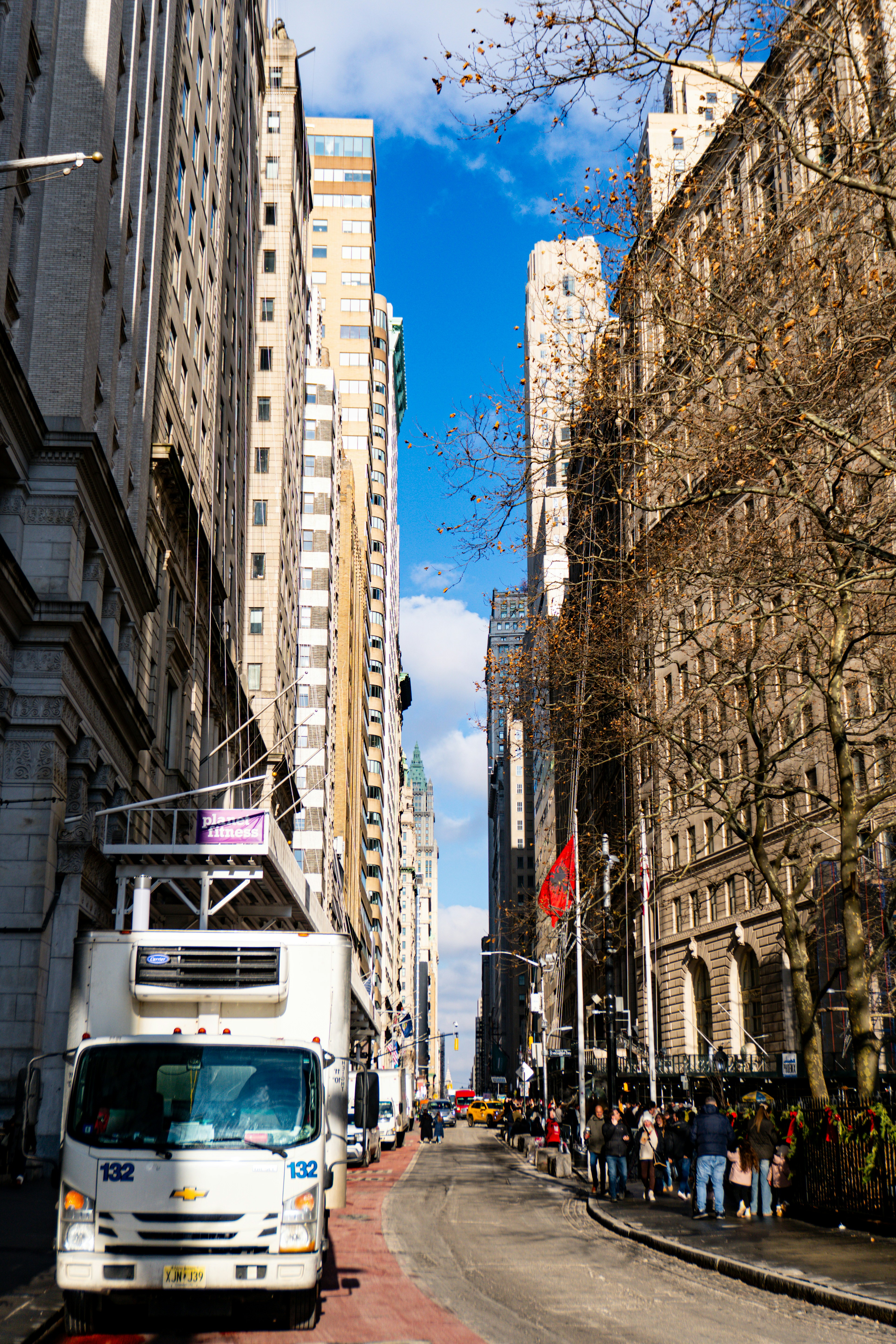 New york city street with tall buildings and people.