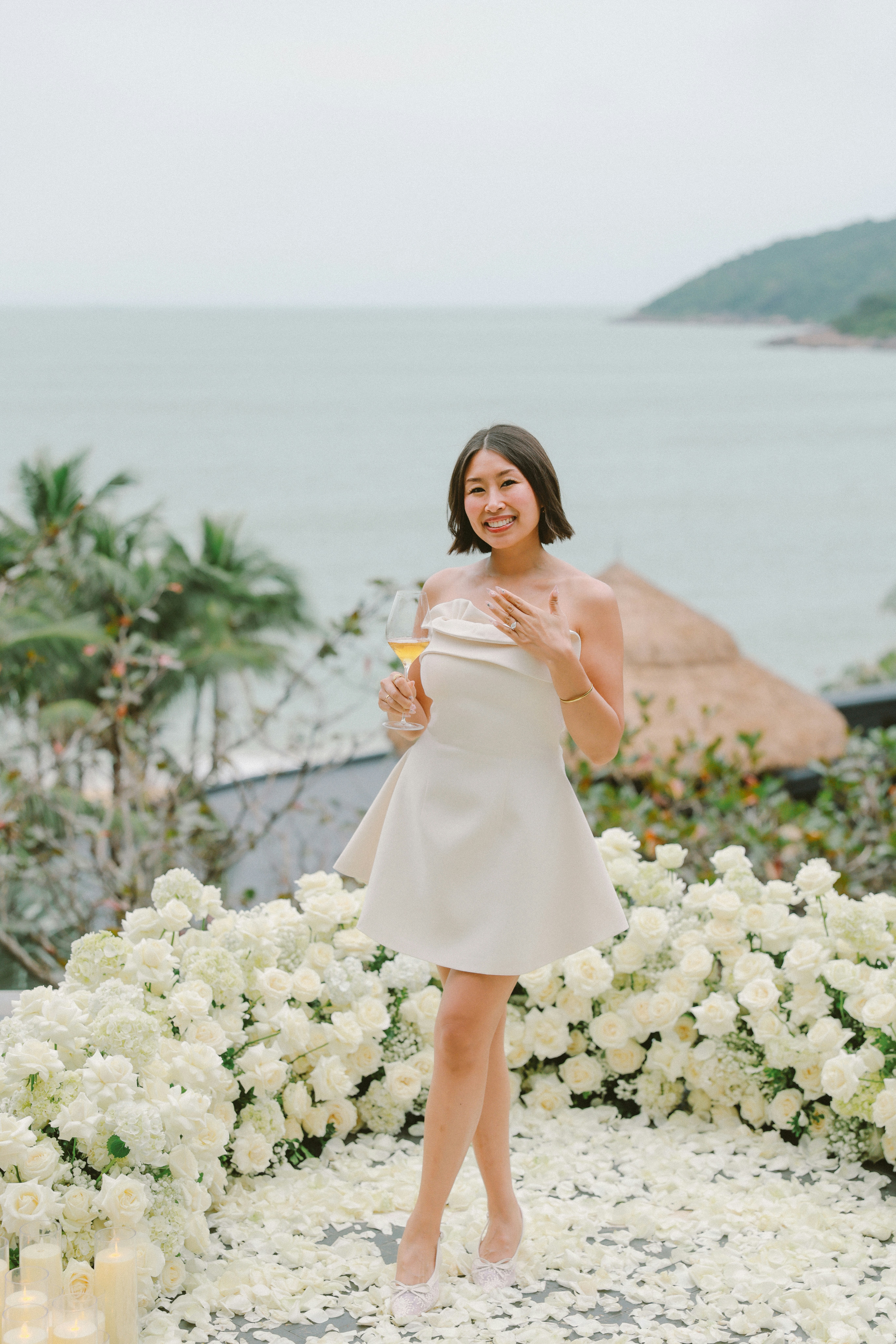 A woman in a dress holding a champagne flute