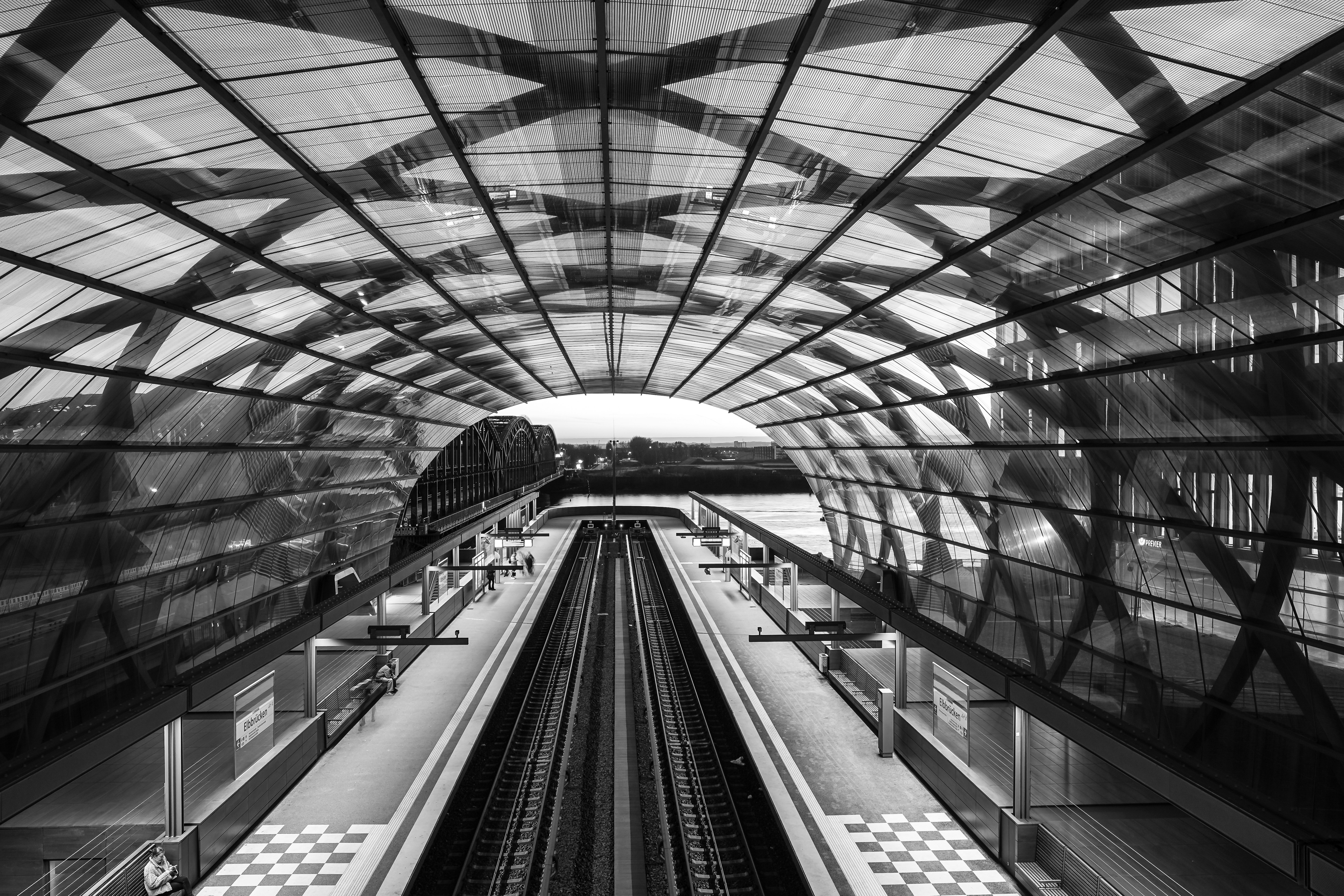 Modern train station with glass roof and tracks