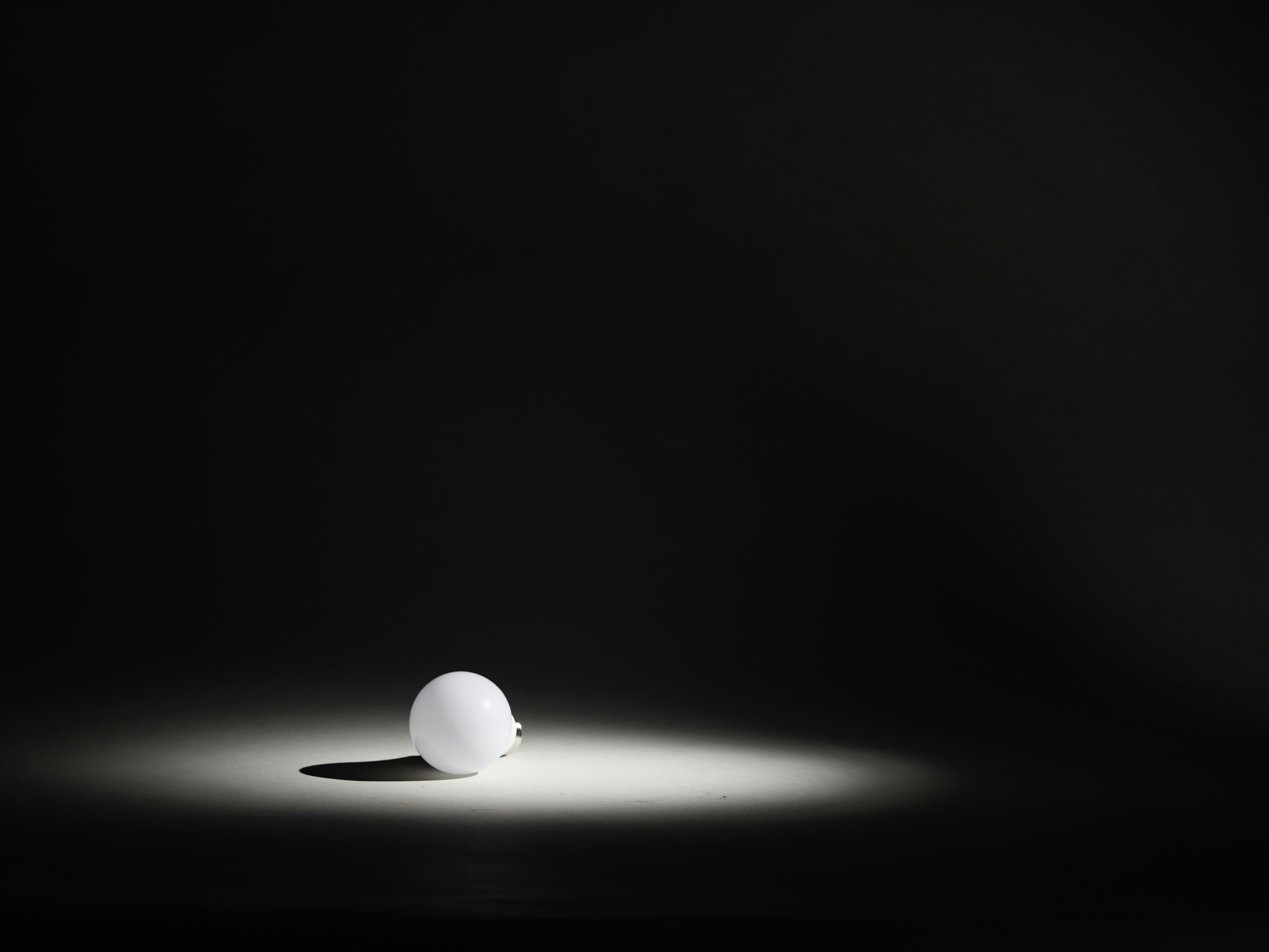 A single white sphere illuminated by a spotlight.