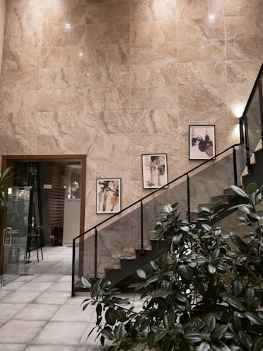 Modern staircase with abstract art on wall.