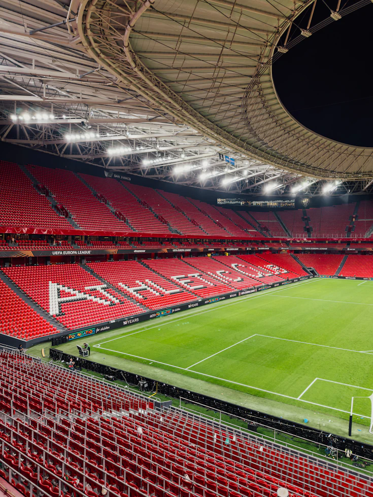 Green football field with stadium structure