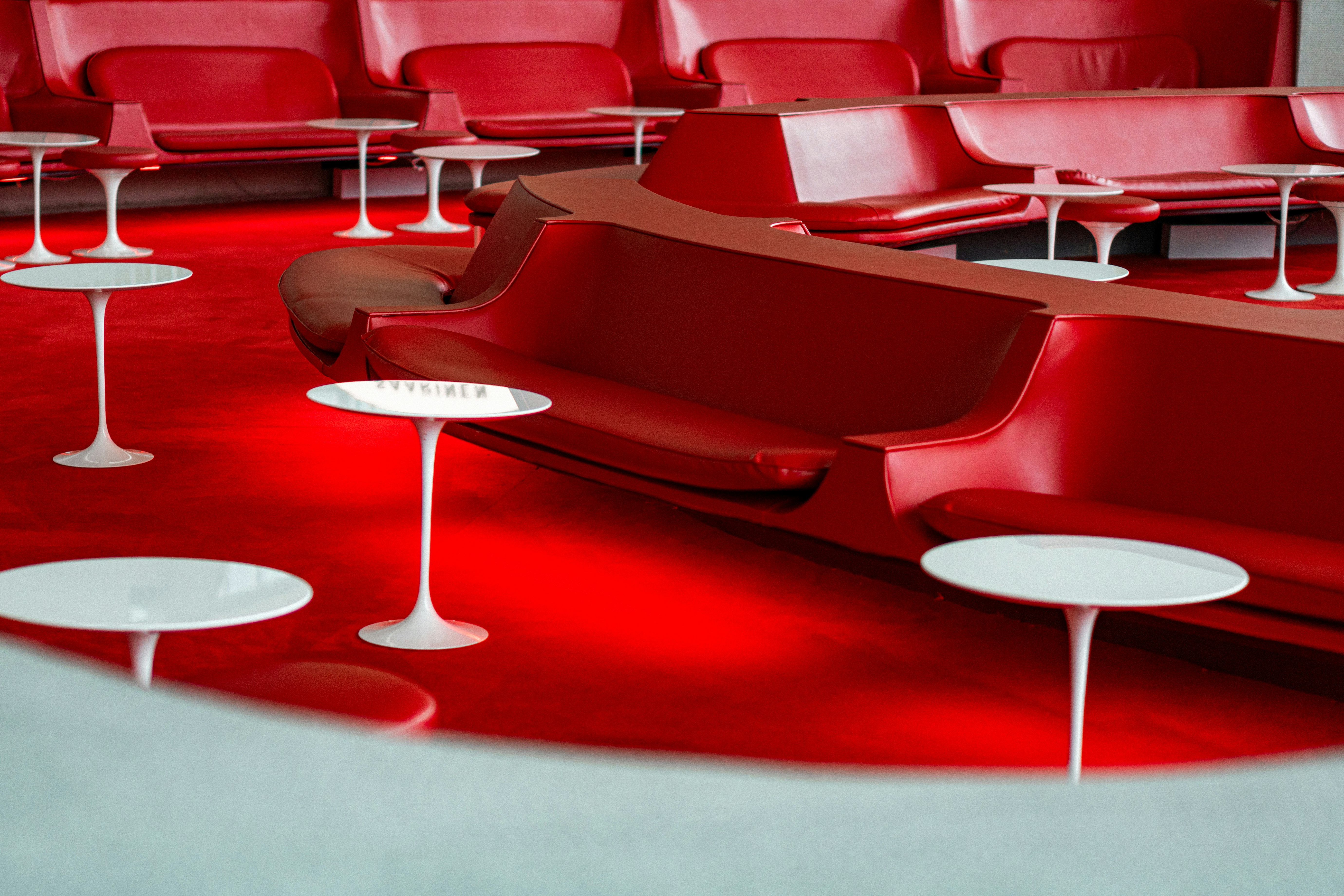 Modern red lounge seating with white tables