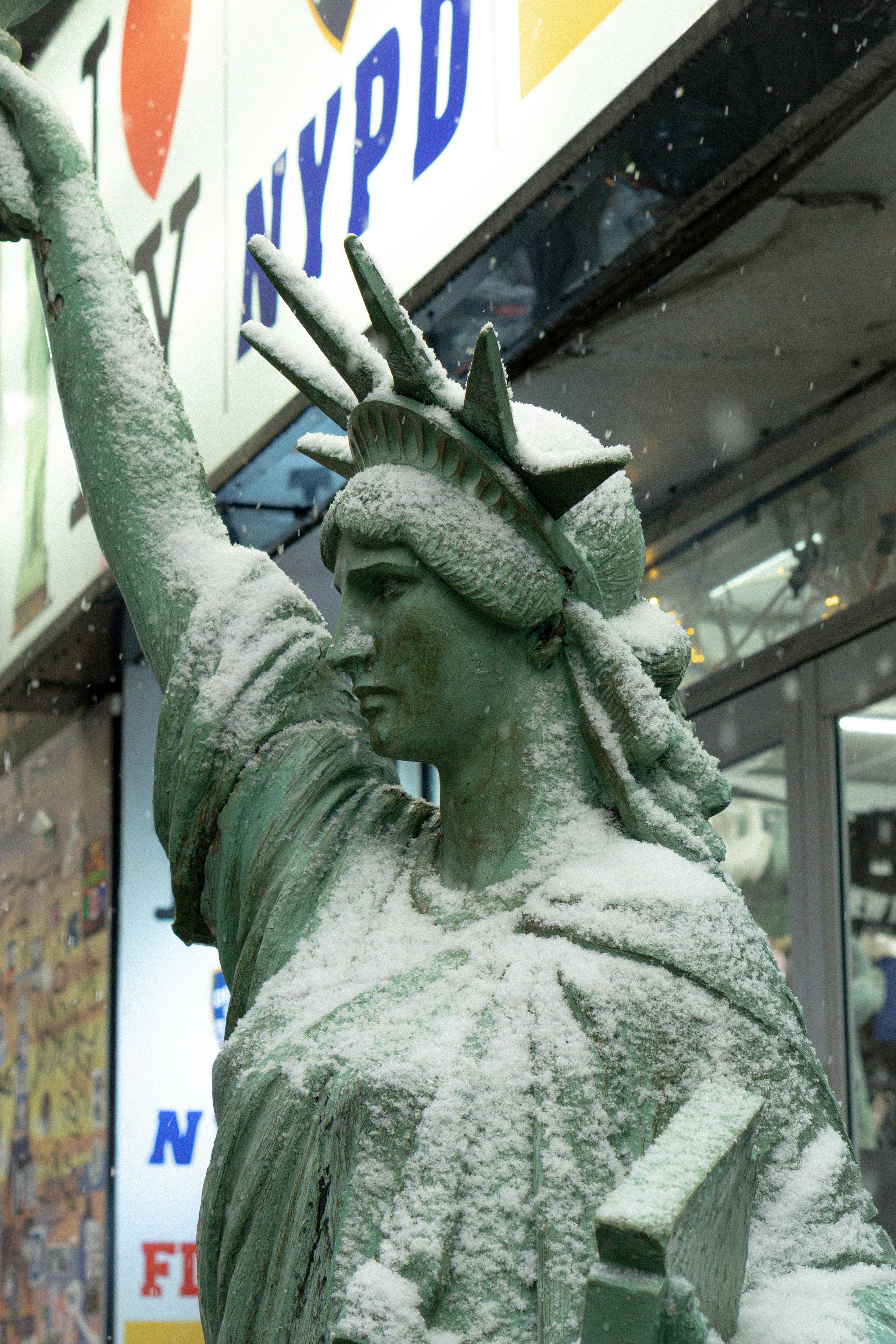 Statue of liberty covered in snow during winter