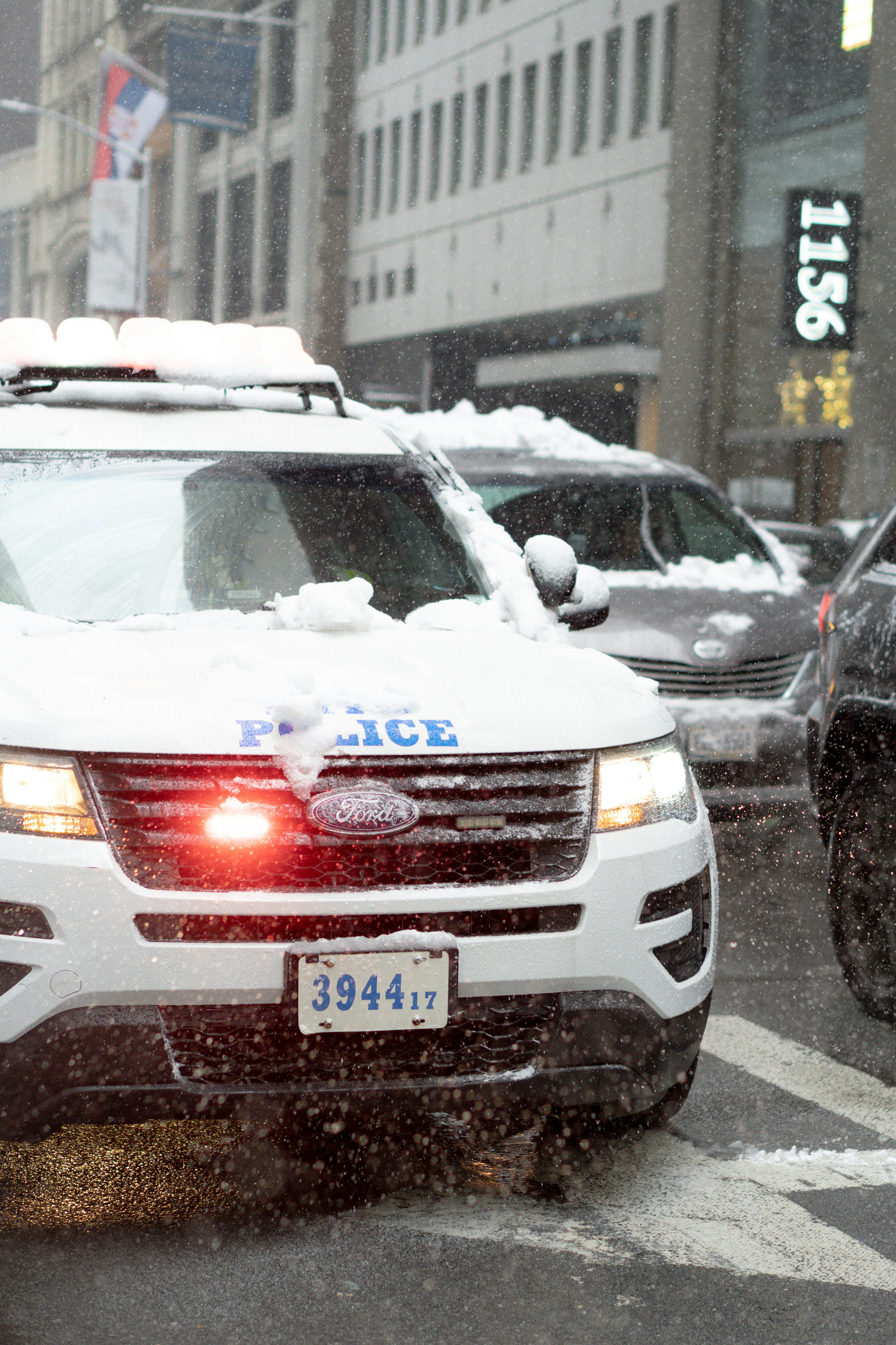 Police car with flashing lights in snow