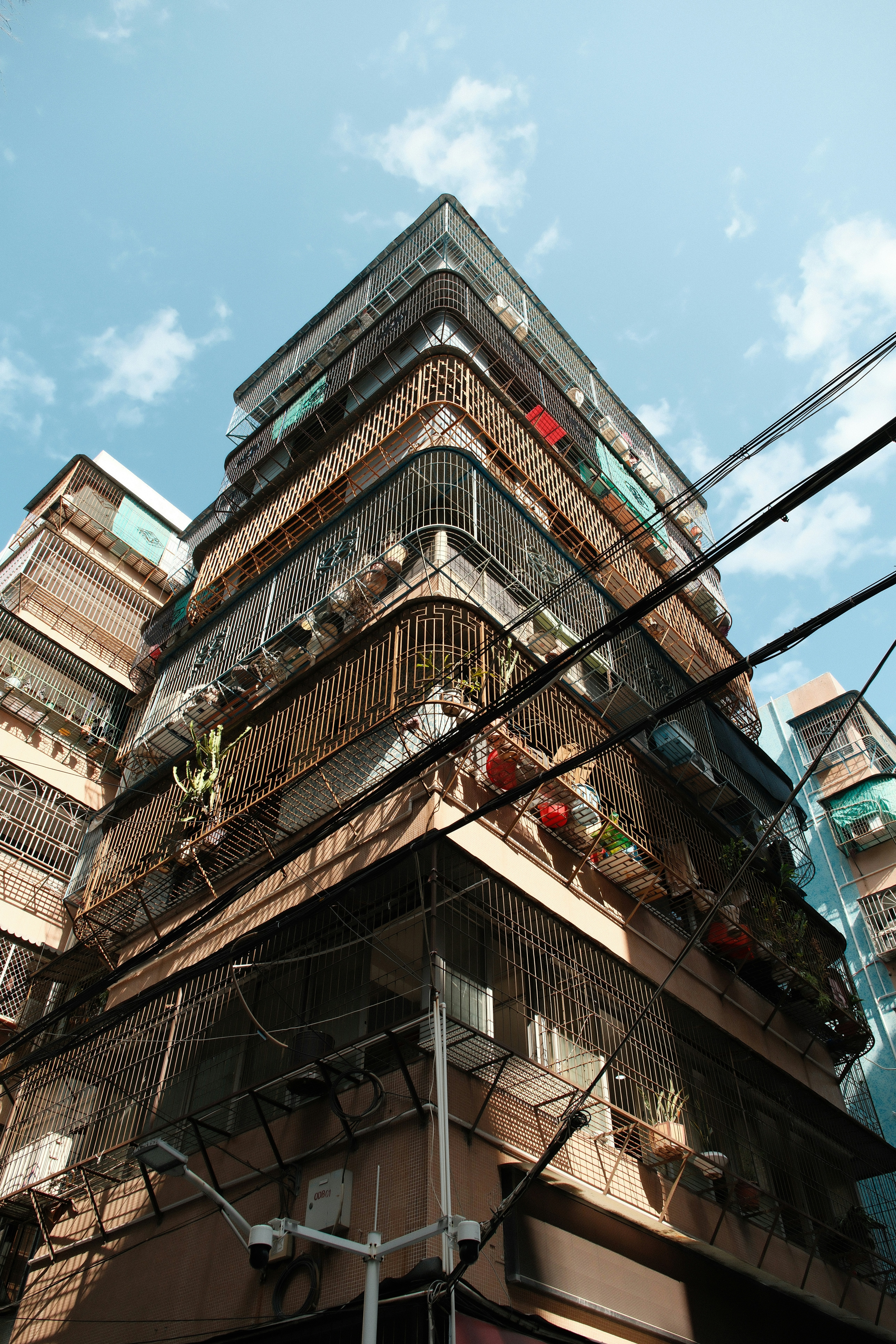 Tall apartment buildings with balconies and wires