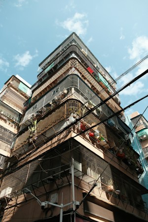 Tall condo and apartment buildings with rows of balconies, the type of attached housing tracked in the September condo price data