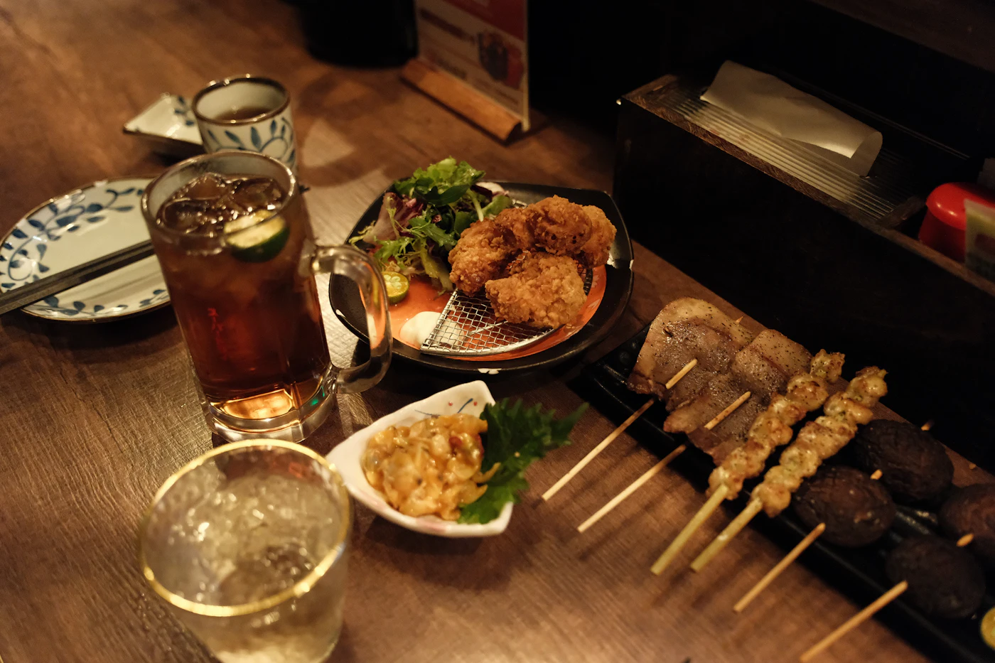 Skewers and glasses on a wooden table
