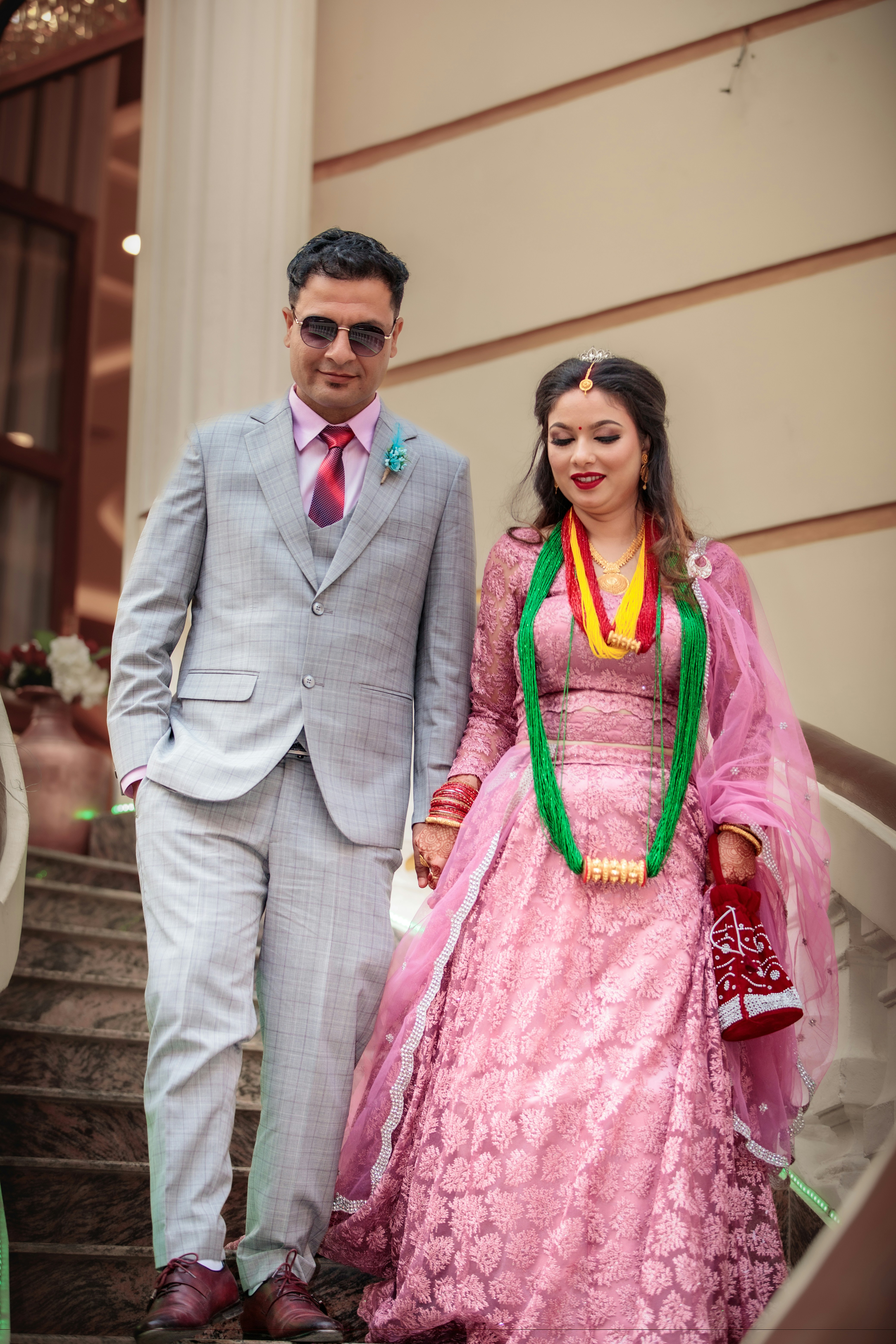 Bride and groom holding hands on stairs