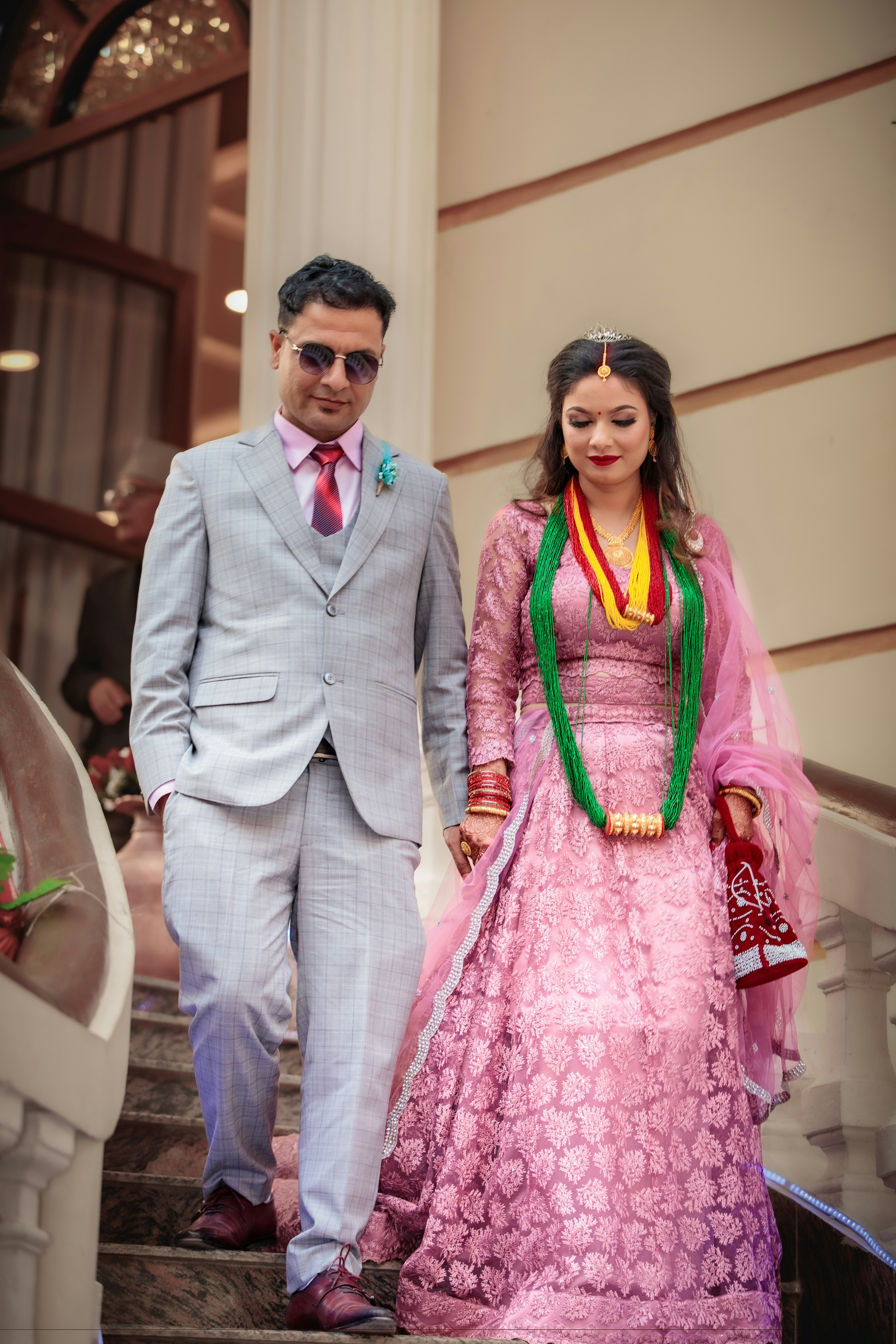 A bride and groom walking down stairs