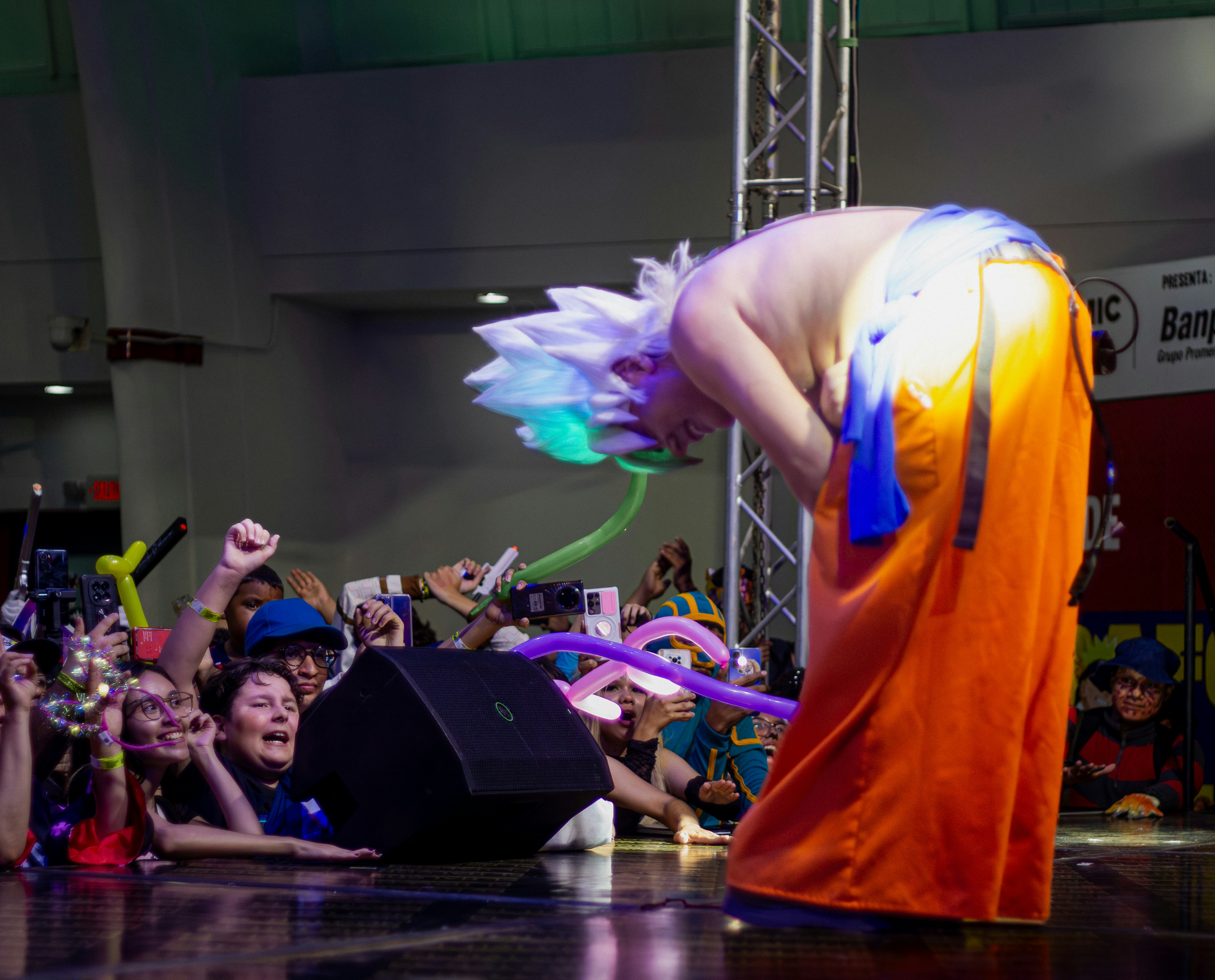 Cosplayer bows to cheering crowd at convention