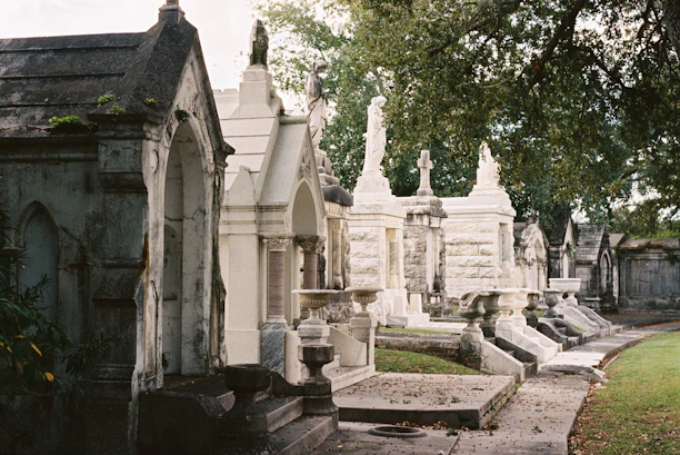 Ornate tombs line a path in a historic cemetery