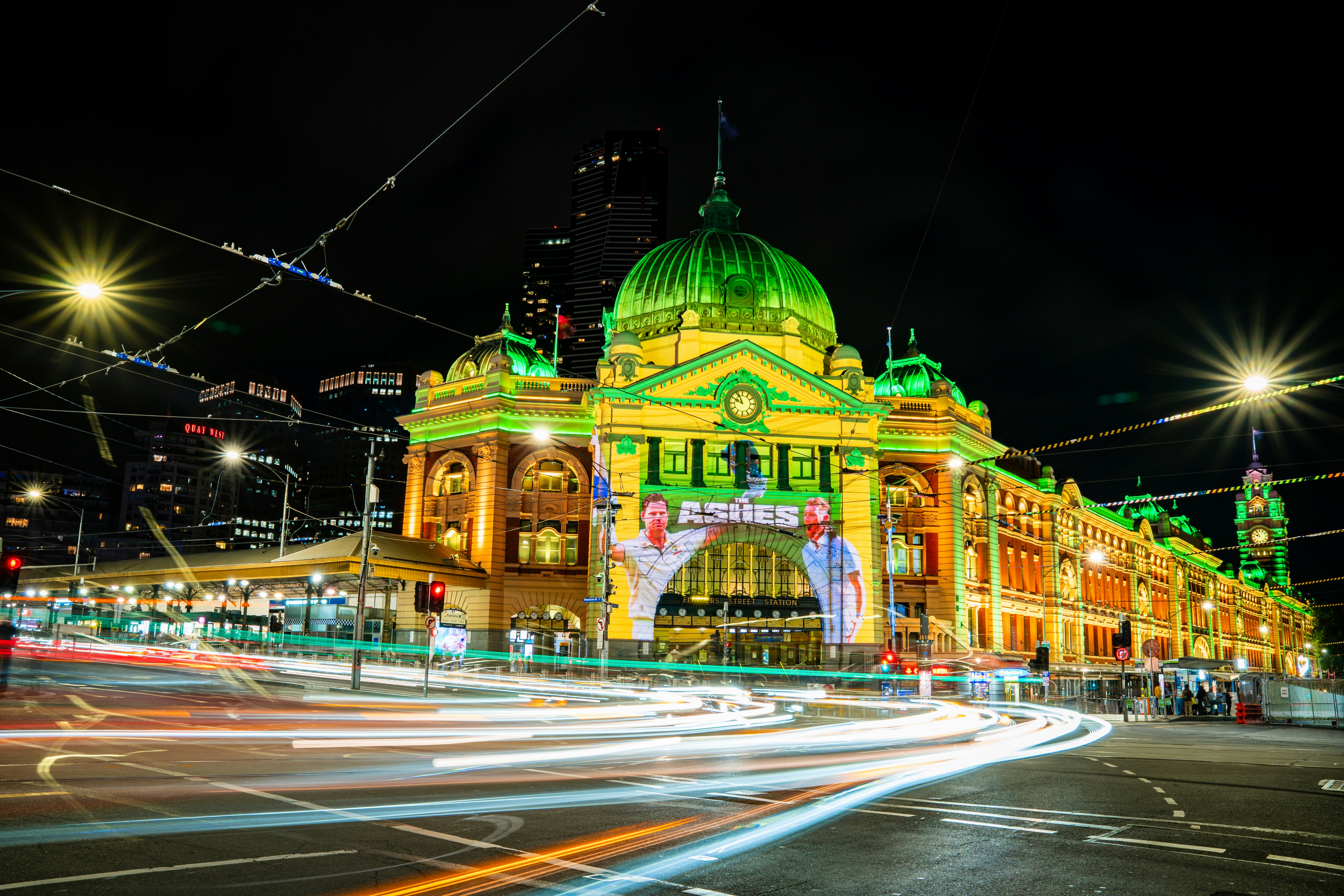 Historic building illuminated at night with light trails