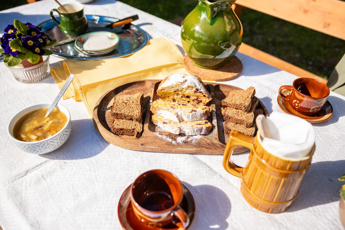 A table set with bread, soup and drinks
