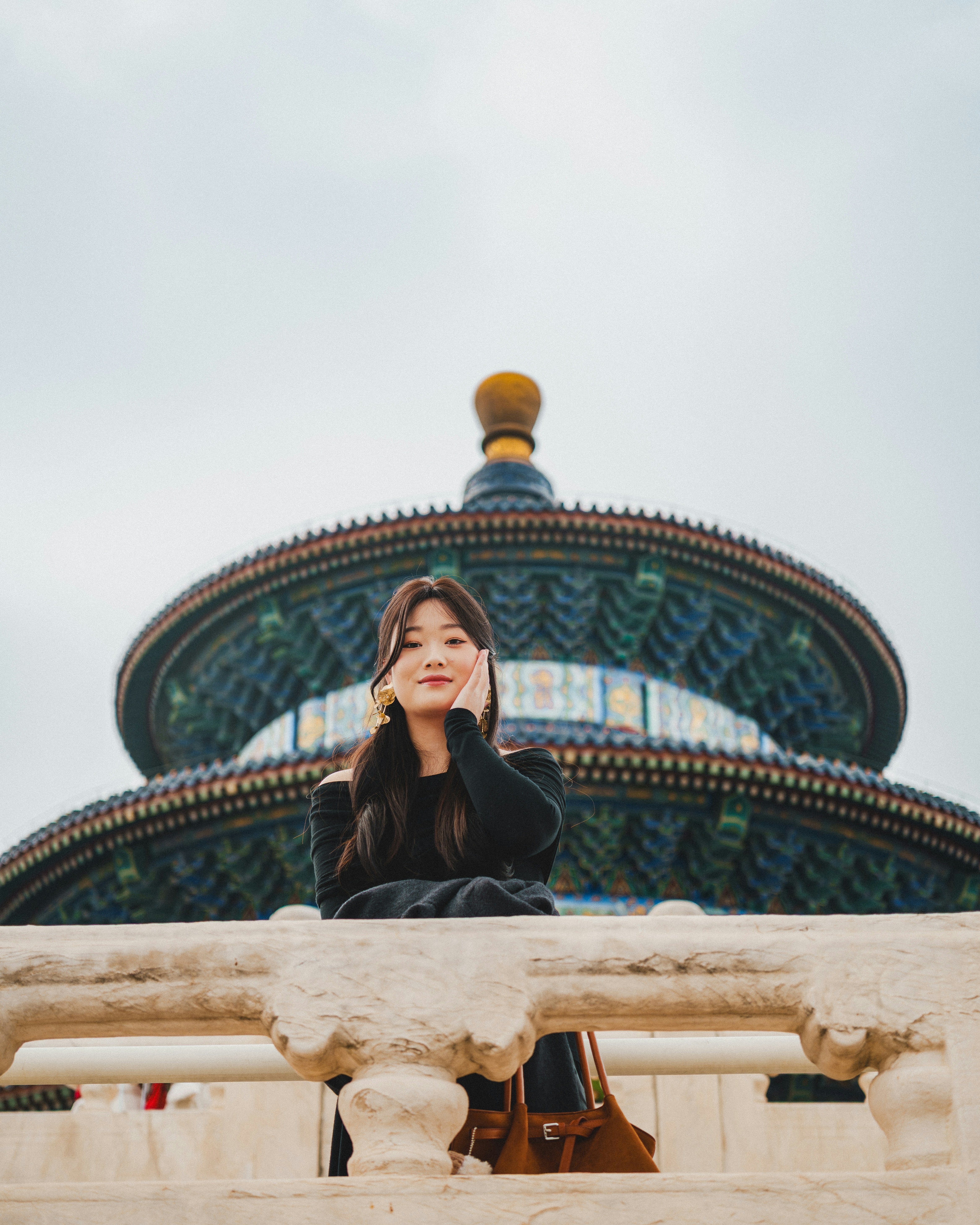 Young woman posing in front of a blue ornate building