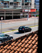 Cars driving on a street with buildings behind