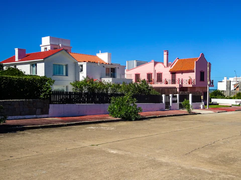 Colorful houses line a street under a clear blue sky.