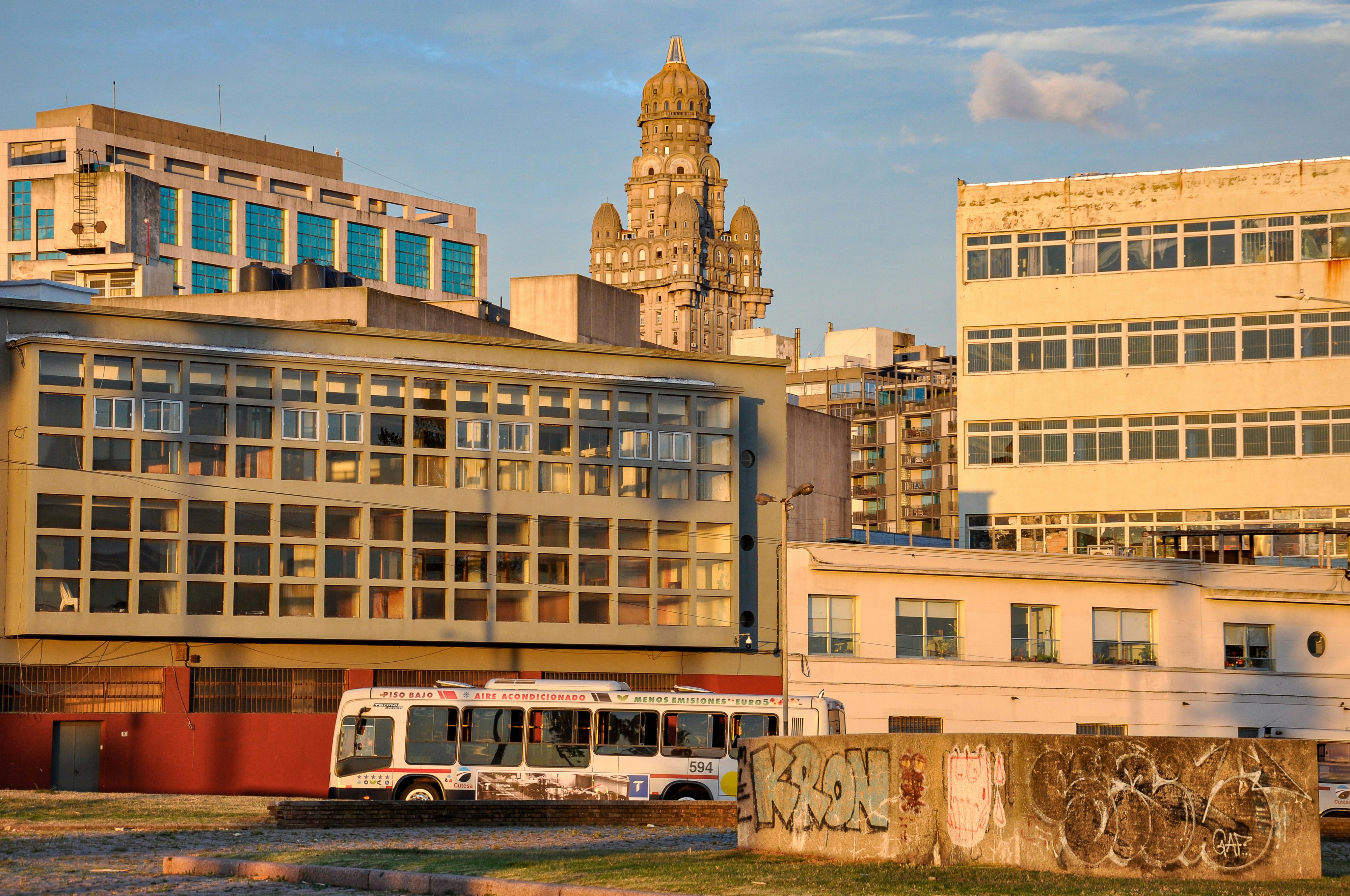 Bus driving past modern buildings in city