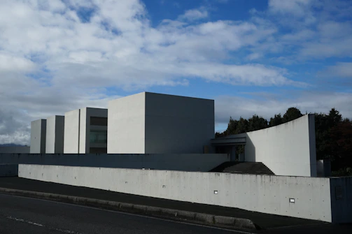 Modern white building with geometric shapes under sky