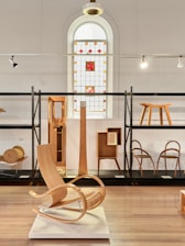 Wooden furniture displayed in a museum exhibition.
