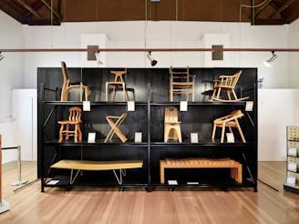 Various wooden chairs displayed on shelves