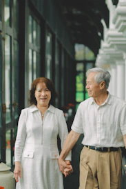 Elderly couple holding hands and smiling