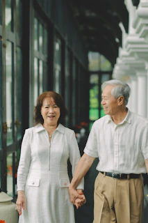 Elderly couple holding hands and smiling
