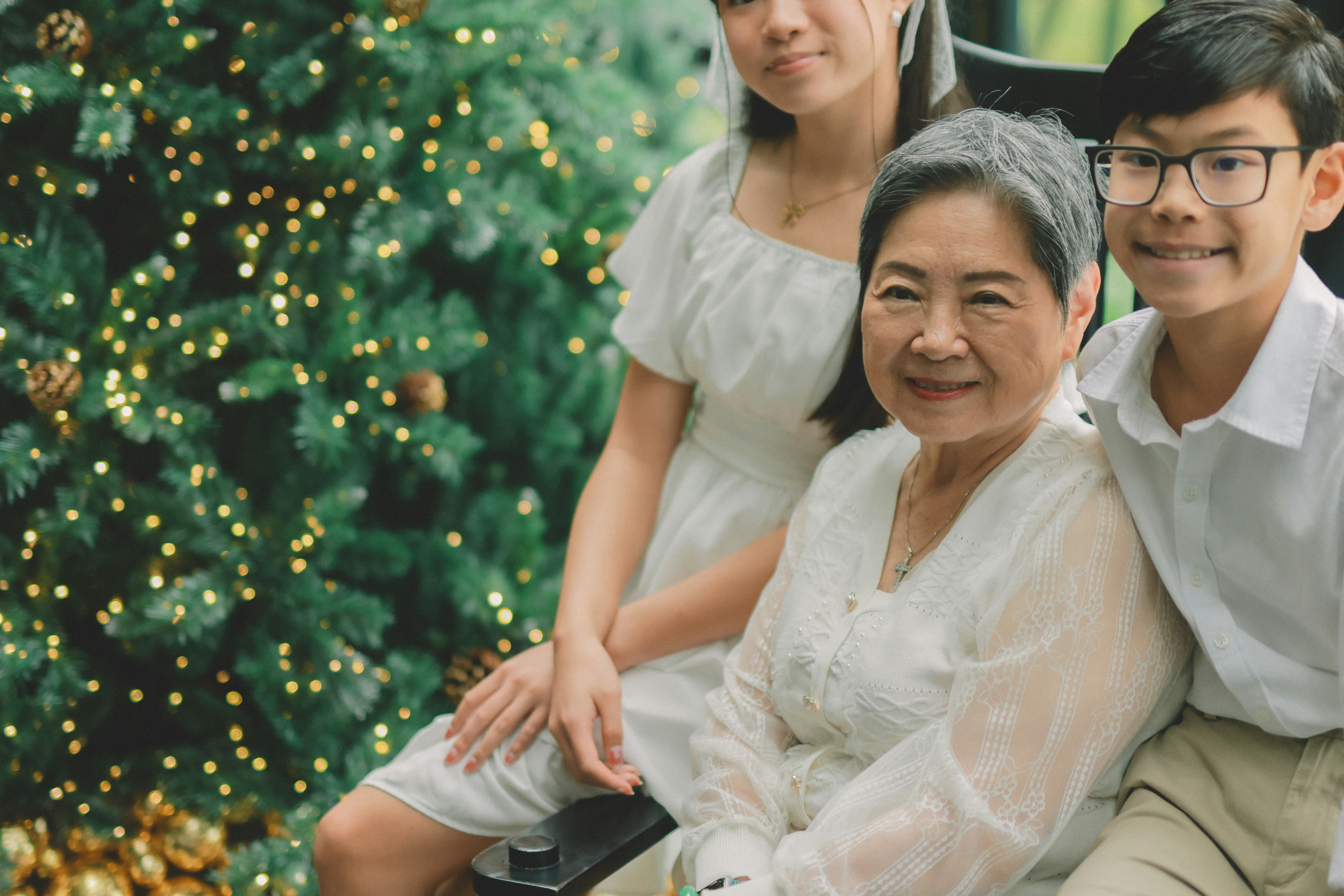 Family posing in front of a decorated christmas tree
