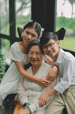 Grandmother with her two grandchildren smiling