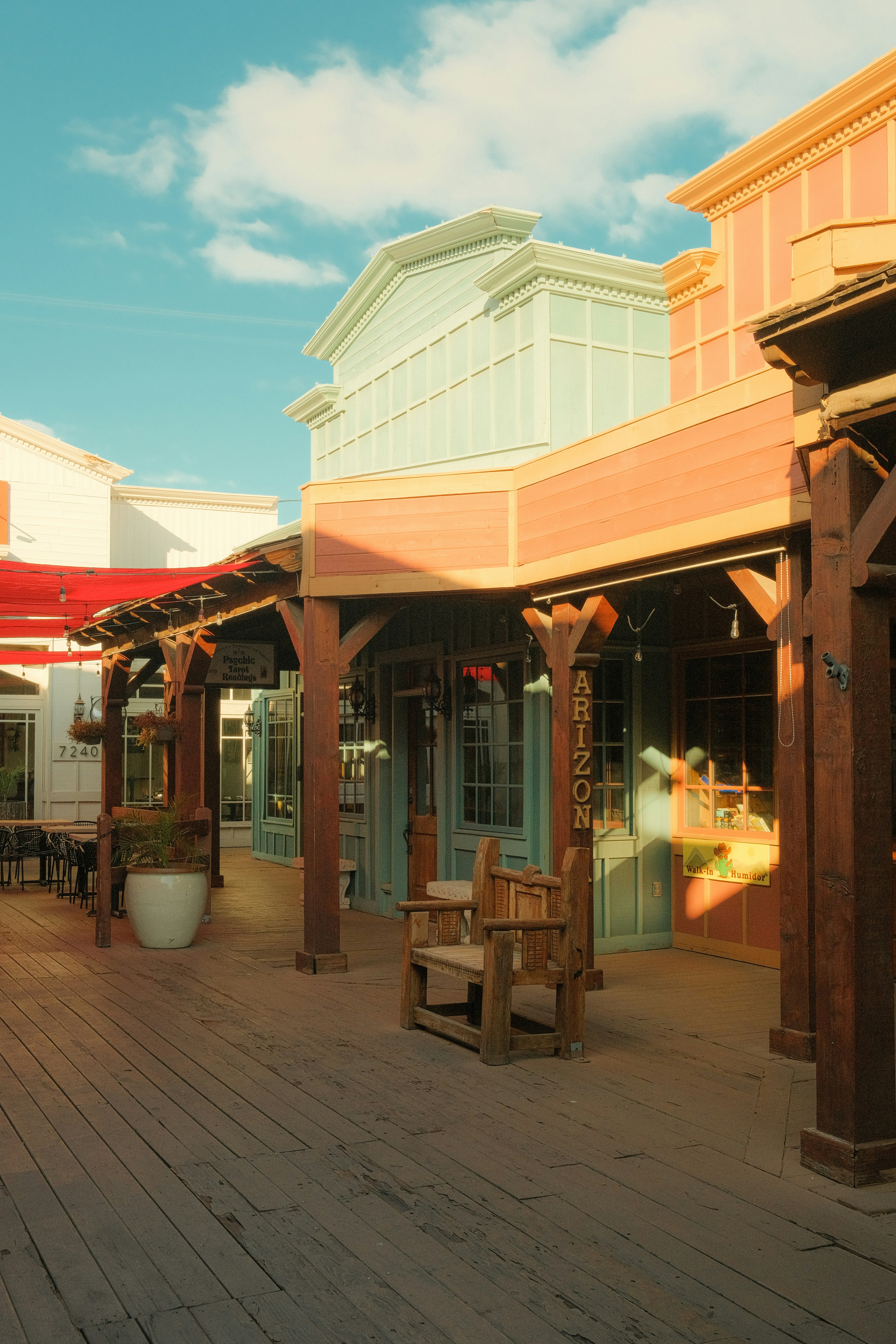 Wooden boardwalk leads to old-fashioned storefronts