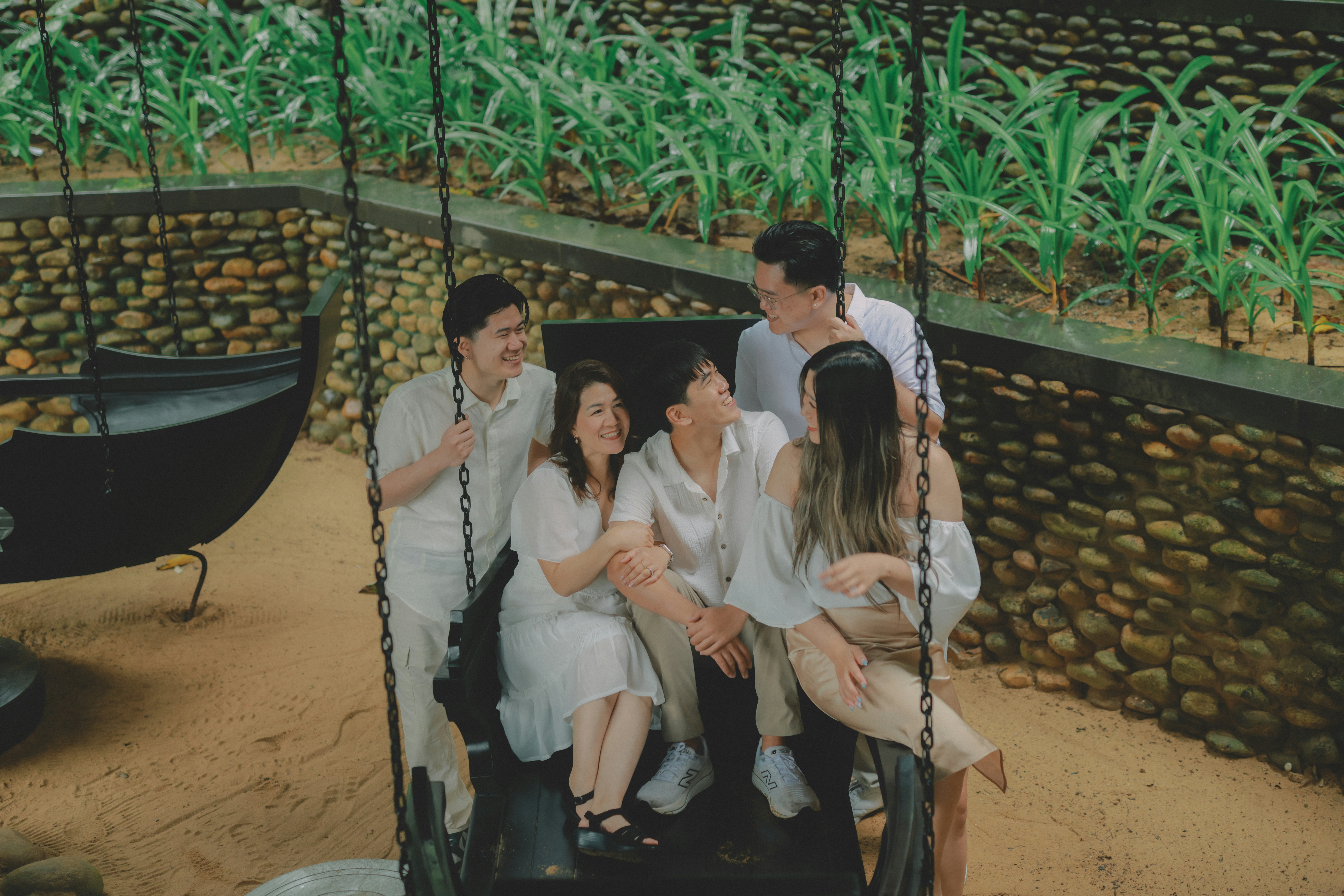 Family laughing together on a swing