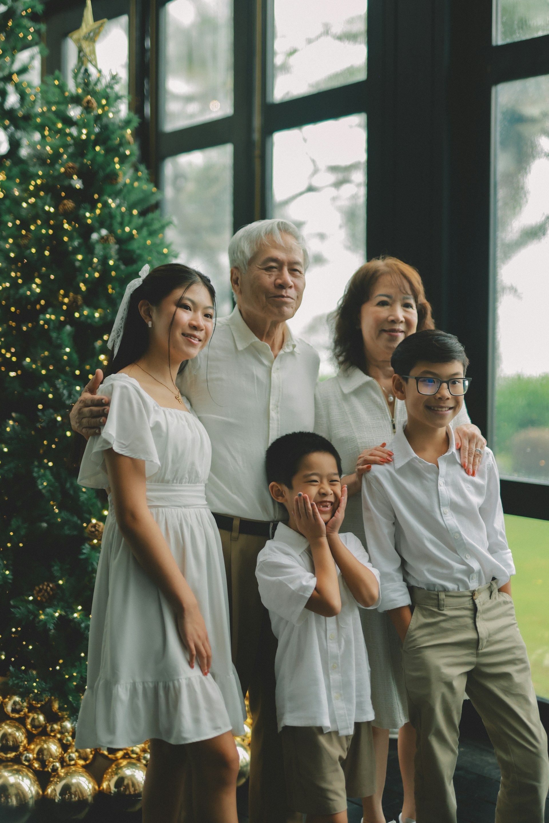 Family posing by a decorated christmas tree