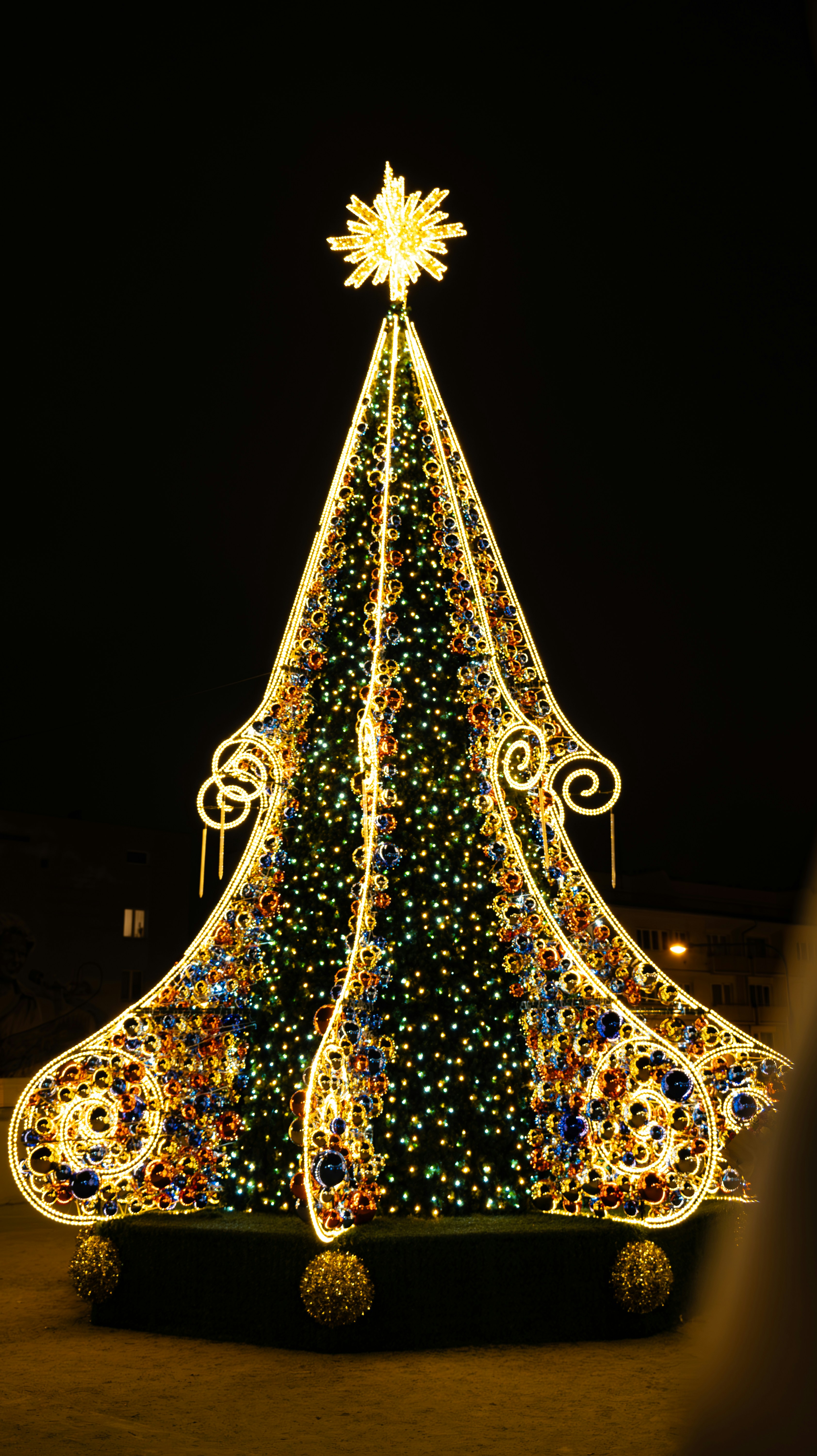 A decorated christmas tree with many lights at night.