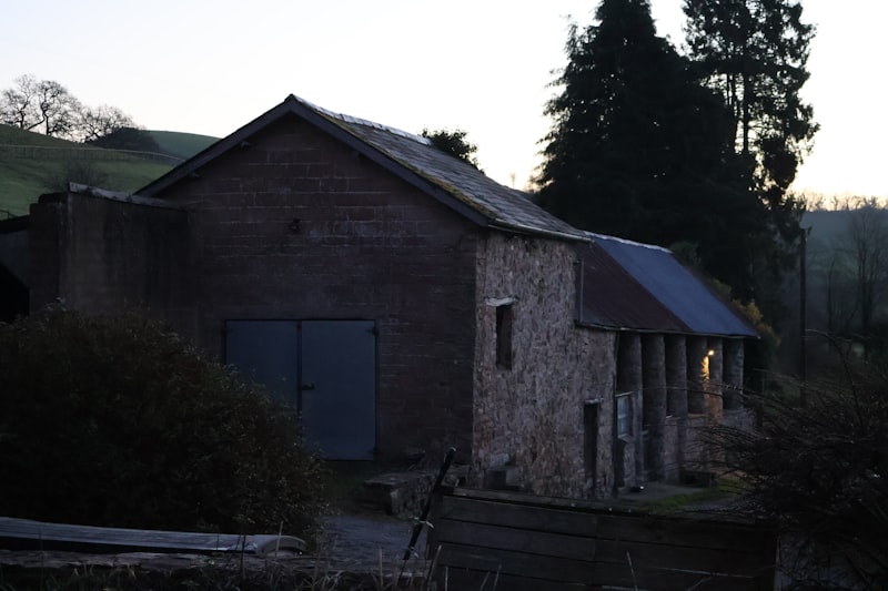 Willow Creek Estate barn exterior at sunset with willow tree