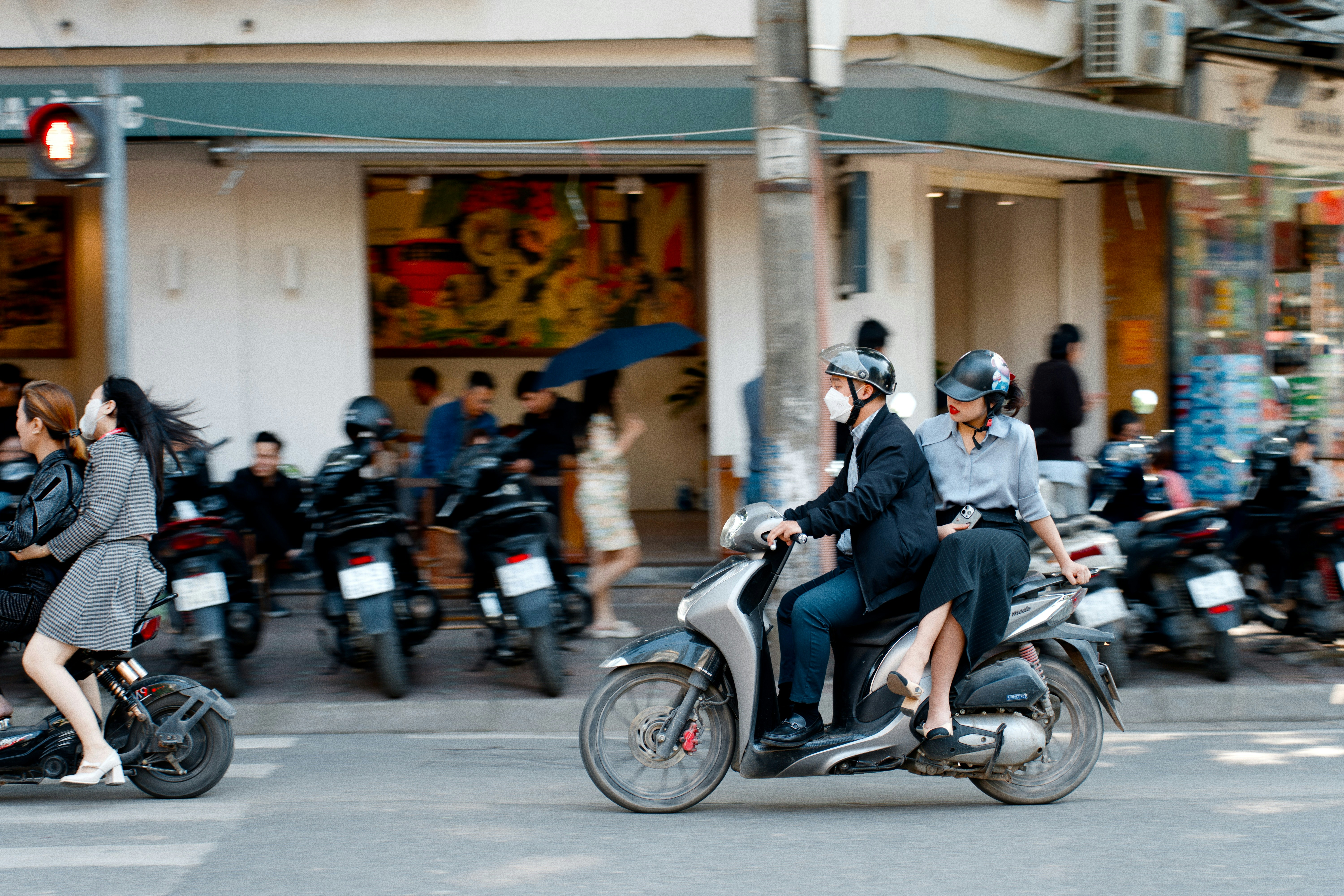 People riding motorbikes on a city street