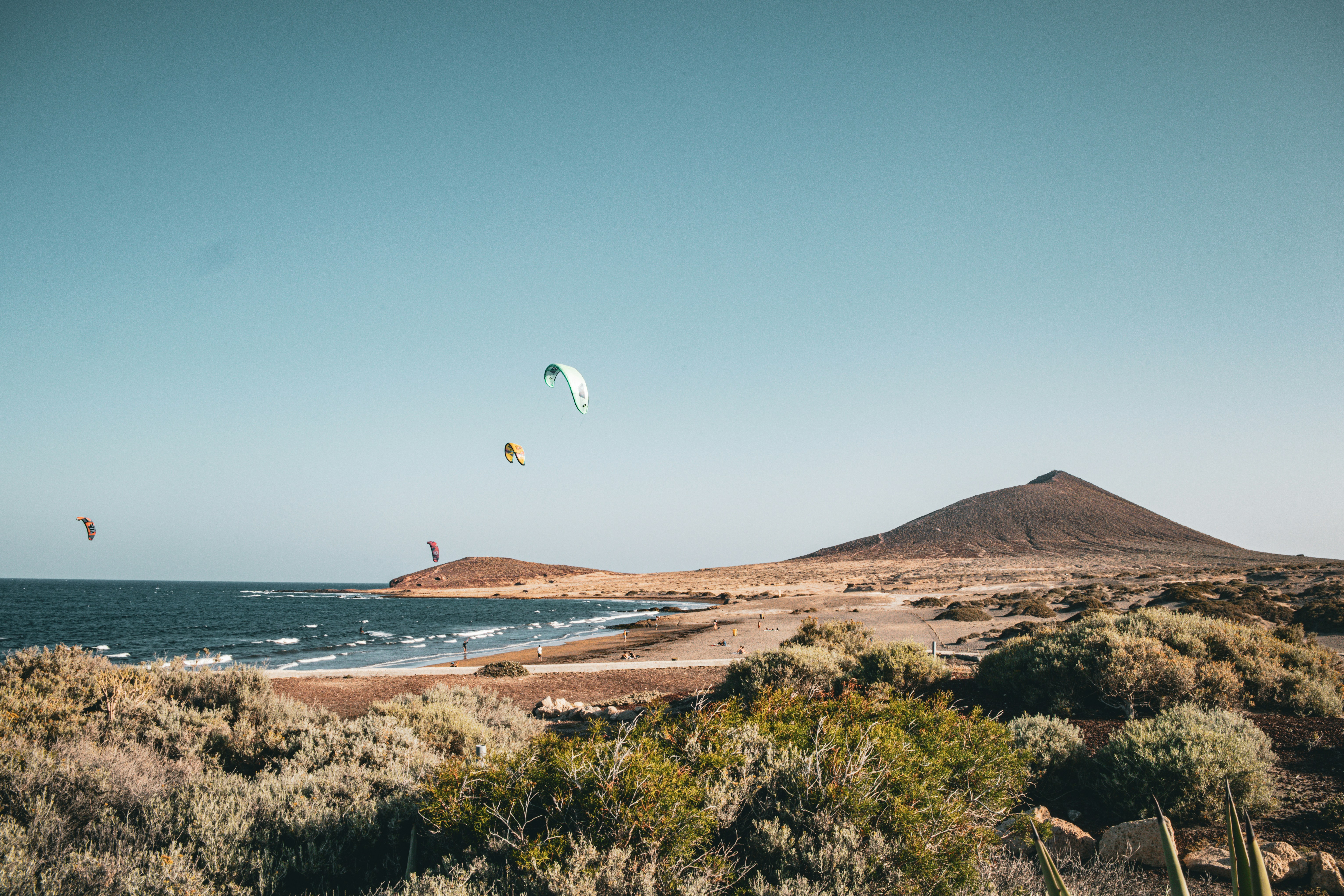 Kitesurfisti in una giornata di sole in spiaggia.