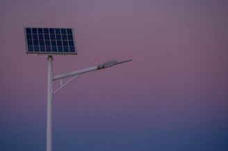 Solar panel street lamp against a twilight sky