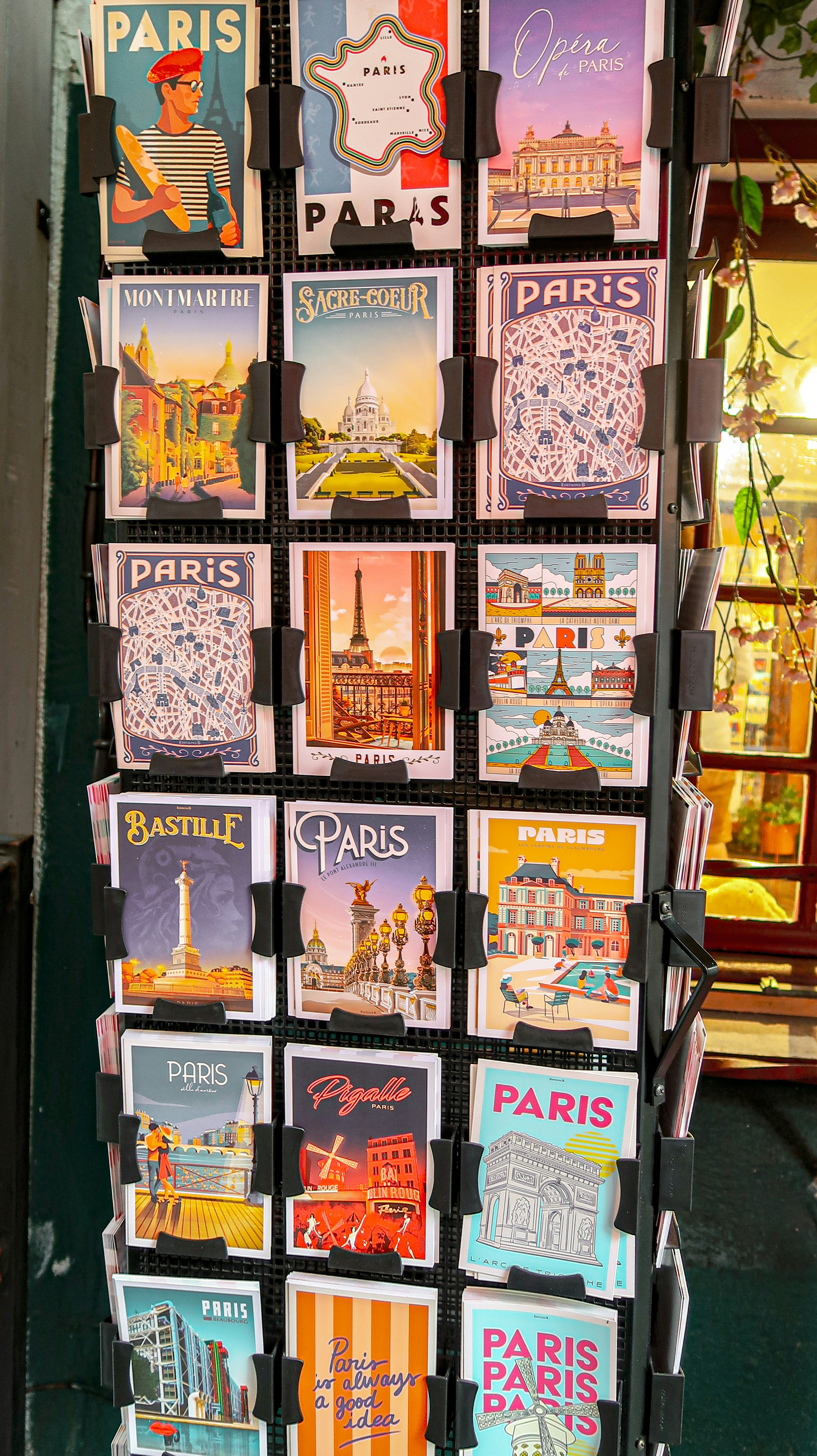 Display rack of colorful paris-themed postcards