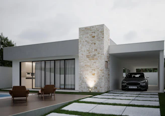 Modern house with a car in the driveway.
