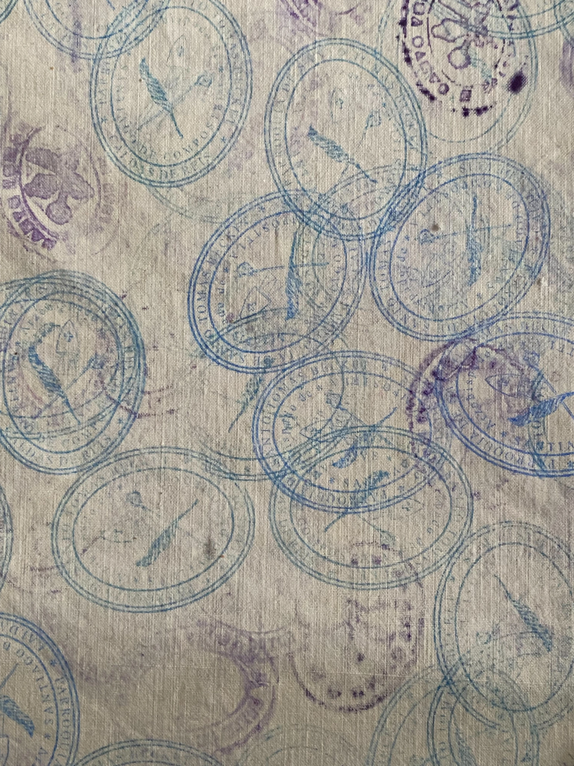 Blue stamps with bird motifs scattered on textured paper