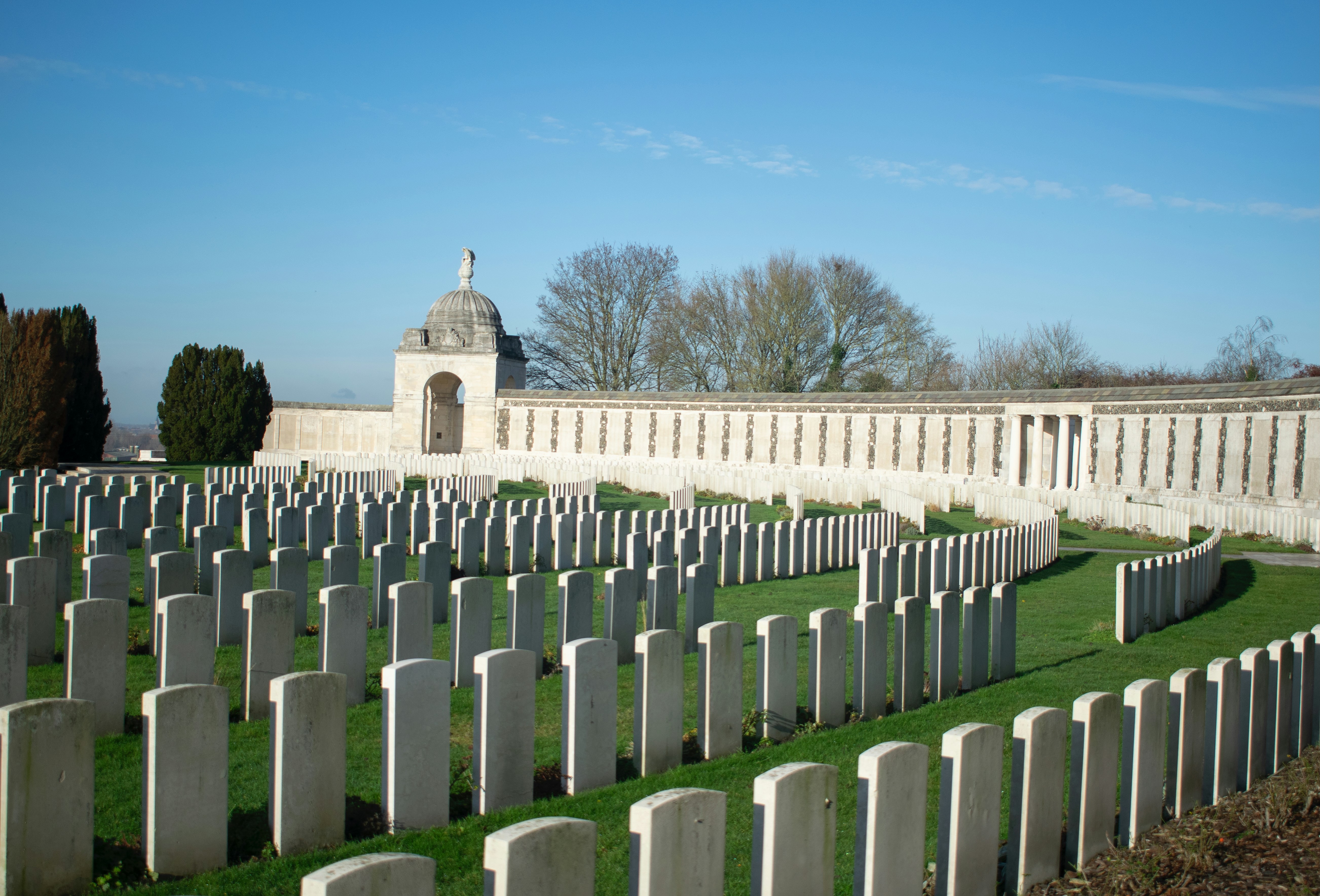 Rows of white headstones in a cemetery