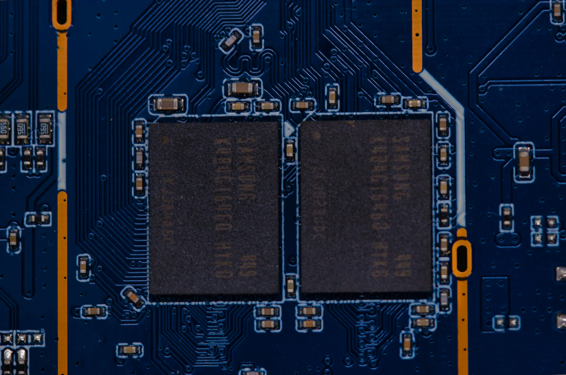 Close-up of a blue circuit board with two large chips.
